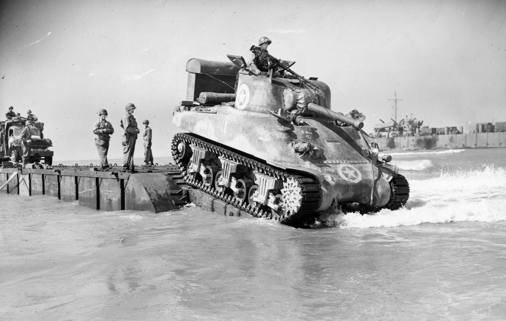 An M4 Sherman tank rolls off a landing craft at Gela Beach. Patton wanted tanks rushed to the front to stymie the enemy attack against his beachhead. 