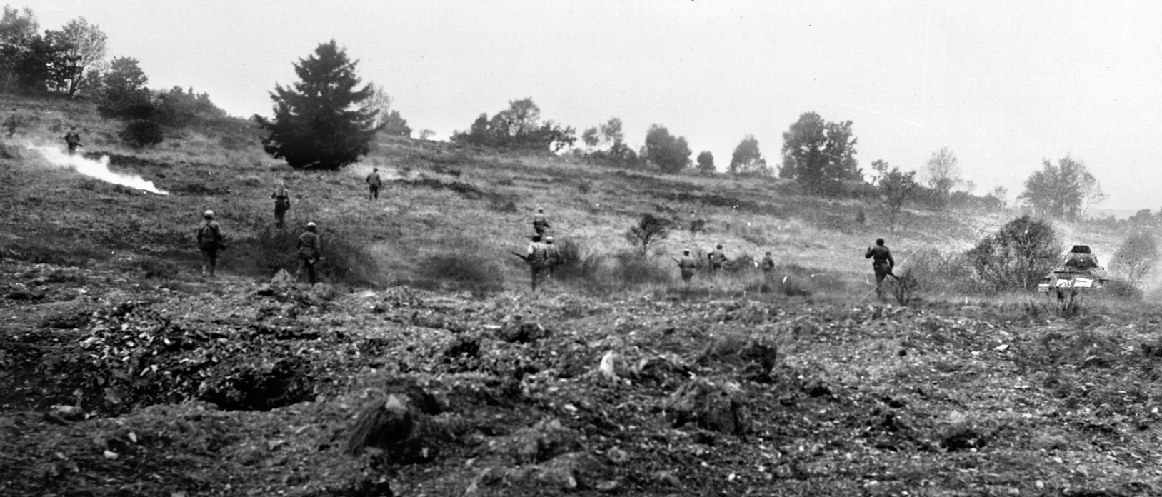28th Division soldiers cross an open field while approaching Siegfried Line defenses. Some of the toughest fighting of the war lay ahead of them.