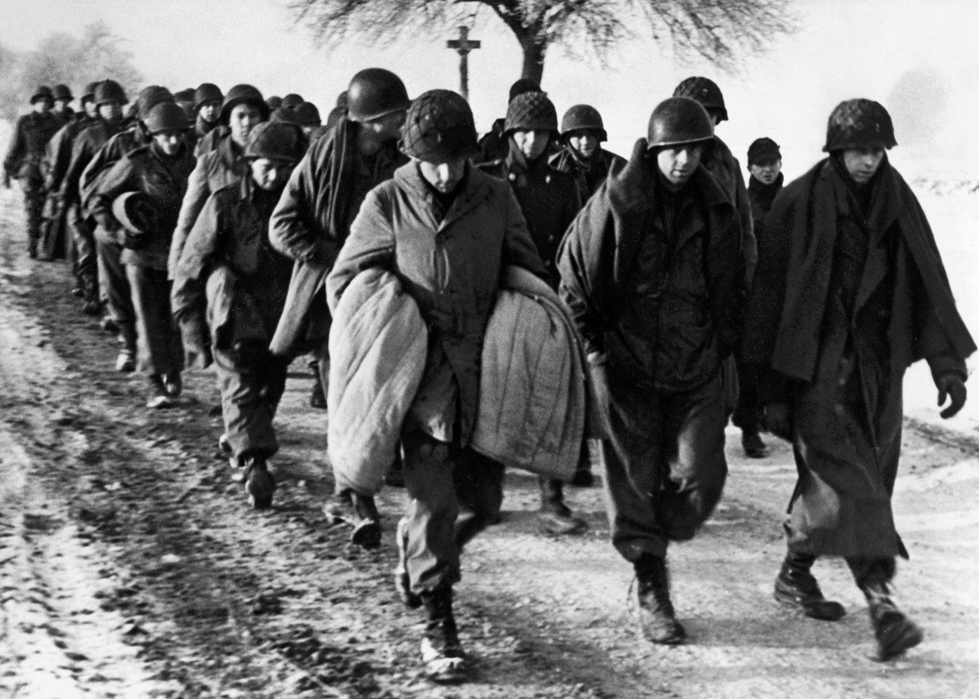 Cold and dispirited, American soldiers, captured during the Battle of the Bulge, are marched to a POW camp behind German lines. Myers was one of hundreds of Americans taken prisoner and held until the end of the war.