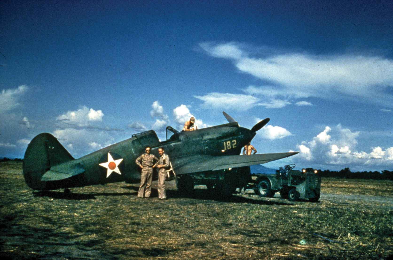 A Curtiss P-40 Tomahawk fighter sits near a runway in the Philippines. Although inferior to the Japanese Mitsubishi Zero, the rugged P-40 was the most advanced American fighter type in service in the Pacific in the early days of the war.