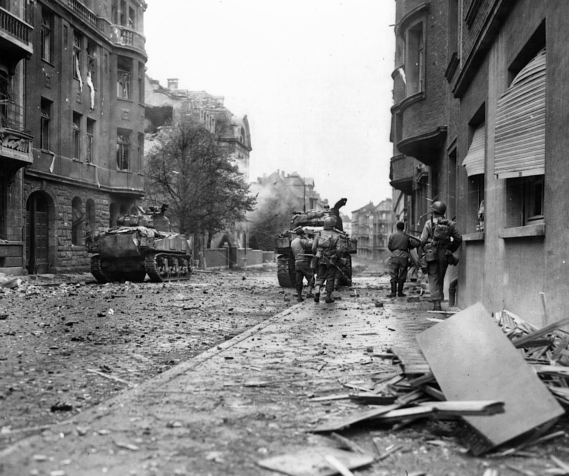 The Americans relied on tanks and and self-propelled guns to blast the Germans out of buildings transformed into strongpoints in Aachen. American tanks advance cautiously through a rubble-strewn street.