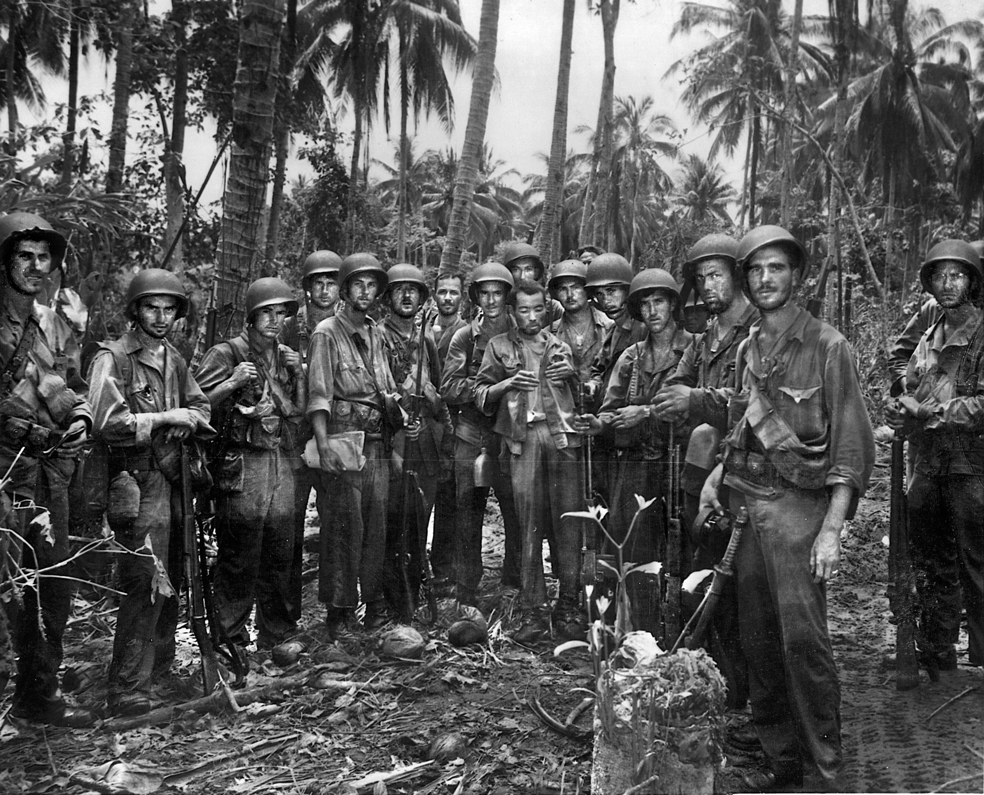 After completing a reconnaissance mission in the jungles of Guadalcanal, a group of U.S. Marines poses for a photographer while delivering a Japanese prisoner for interrogation. The Marine at right has taken a Japanese sword as a souvenir. Prisoners were rarely taken in the Pacific, as Japanese soldiers preferred suicide to captivity.