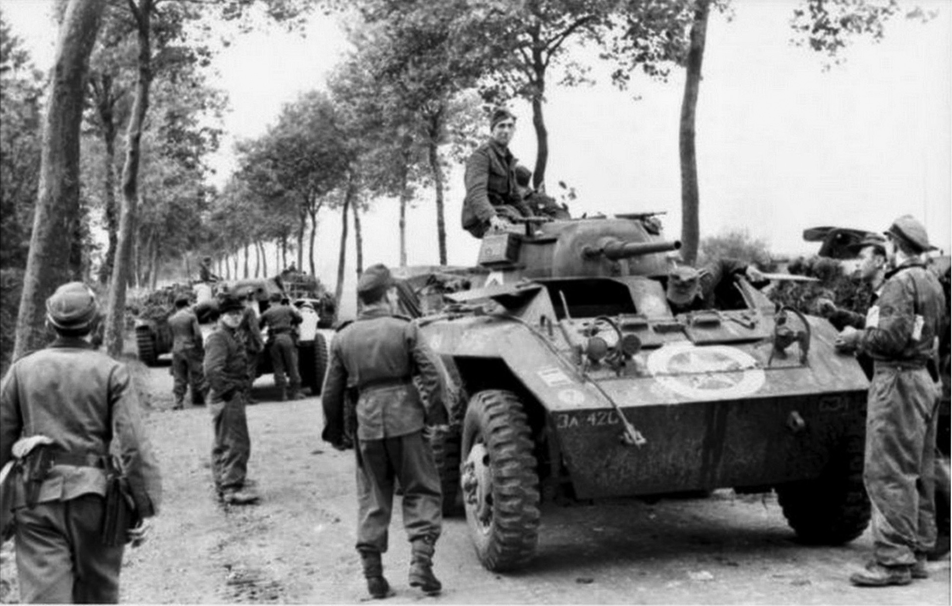 In this photo taken near Luneville in 1944, German soldiers make use of American-built M8 Greyhound armored cars they have previously captured. The original owners of the armored cars were the troops of the U.S. 42nd Cavalry Squadron, and the Germans belong to Panzerbrigade 111.