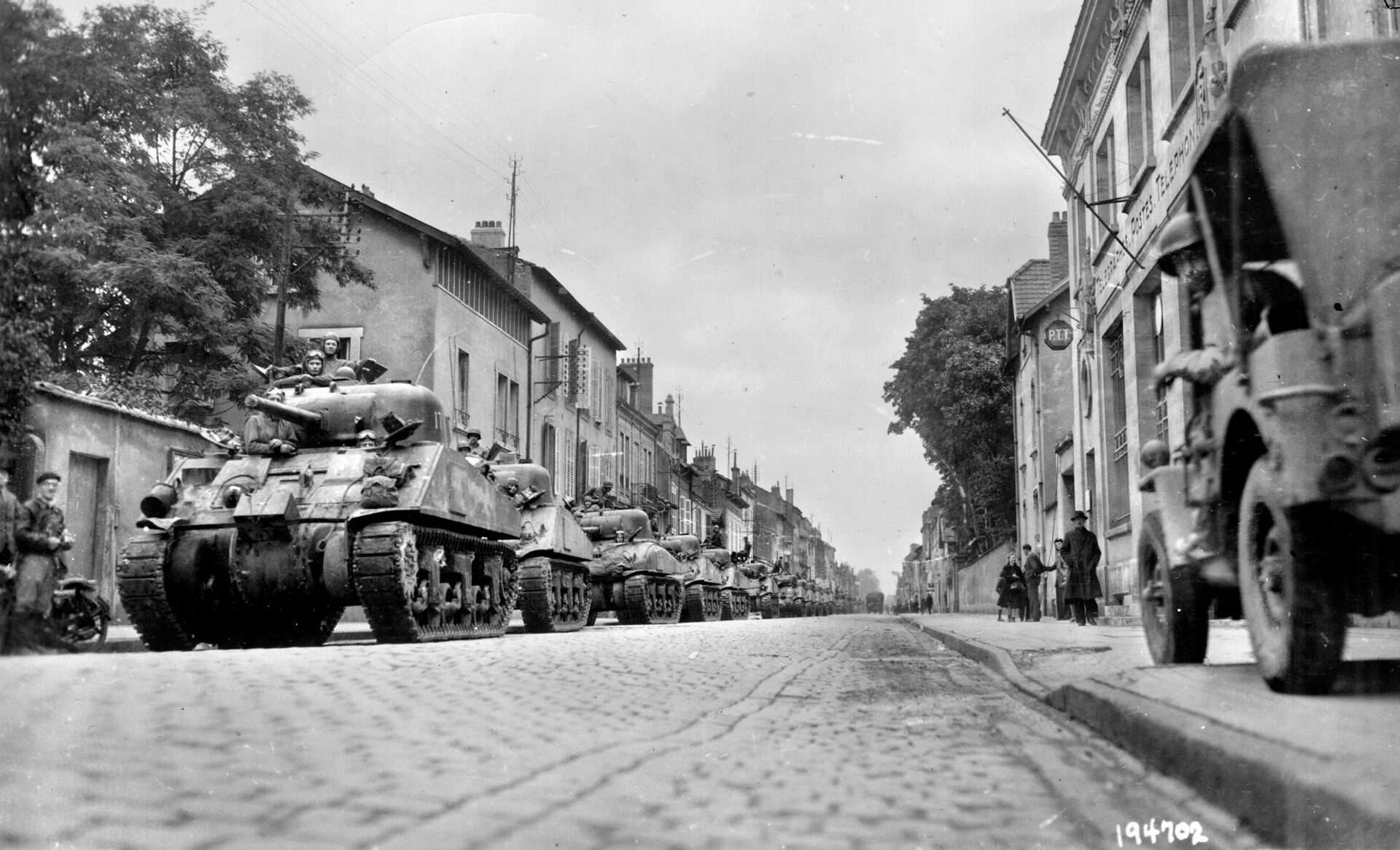 This photo was taken a week after the fighting in and around Luneville ended in the fall of 1944. A long line of American M4 Sherman medium tanks has halted temporarily during the Third Army advance through France toward the German frontier.