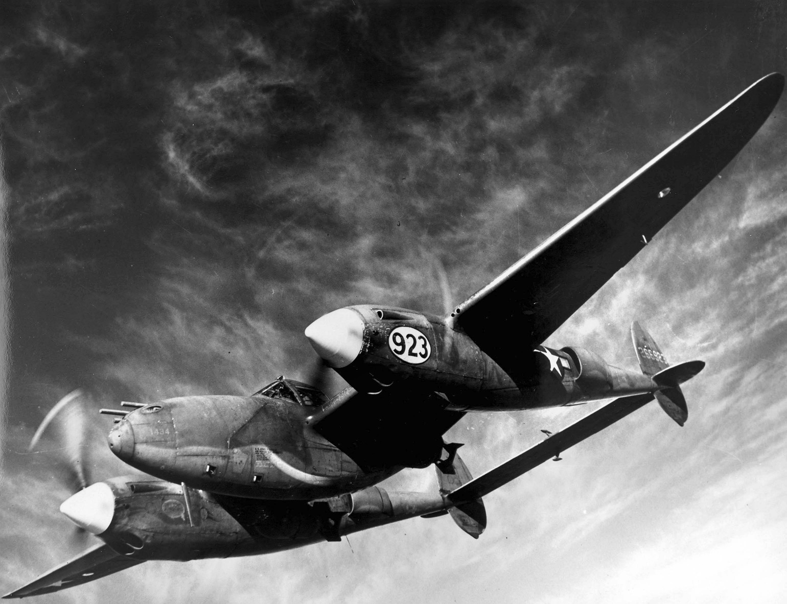 This P-38 Lightning is equipped as a fighter-bomber, with its bomb load beneath each wing. The versatile aircraft was capable as a dog fighter and reconnaissance aircraft, as well. 