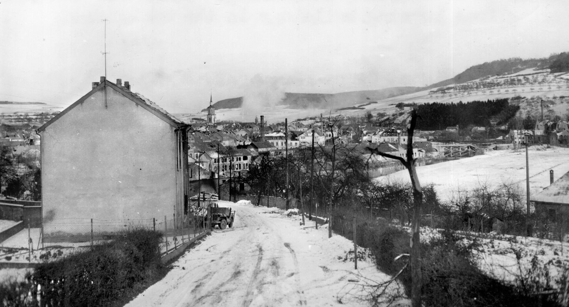 In this distant view of the opposite bank of the Sauer River at Echternach, Luxembourg, American artillery shells land near German pillboxes and machine-gun nests in preparation for the 5th Infantry Division crossing, which took place on January 18, 1945. 