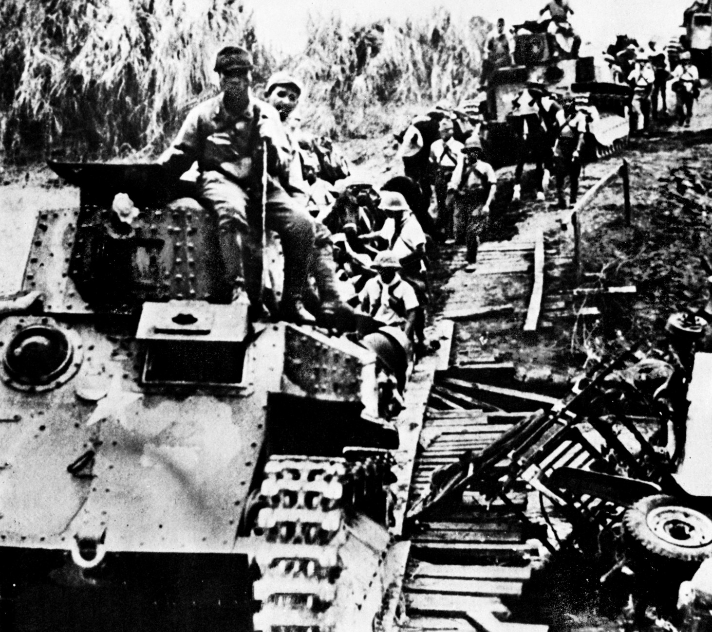 During their rapid advance in the CBI in 1942, Japanese troops and tanks cross a rickety bridge somewhere in Burma. The Japanese capture of Rangoon, the Burmese capital, marked the nadir of Allied fortunes in the CBI. 
