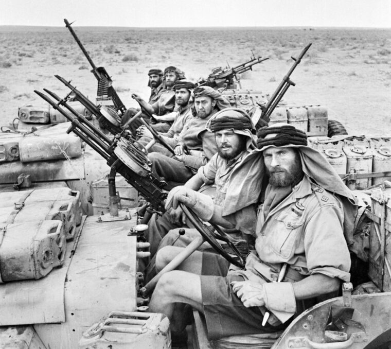 SAS veterans of the Desert War photographed just after completing a three-month patrol. Their Jeeps are armed with machine guns and include Jerry cans containing fuel and water.