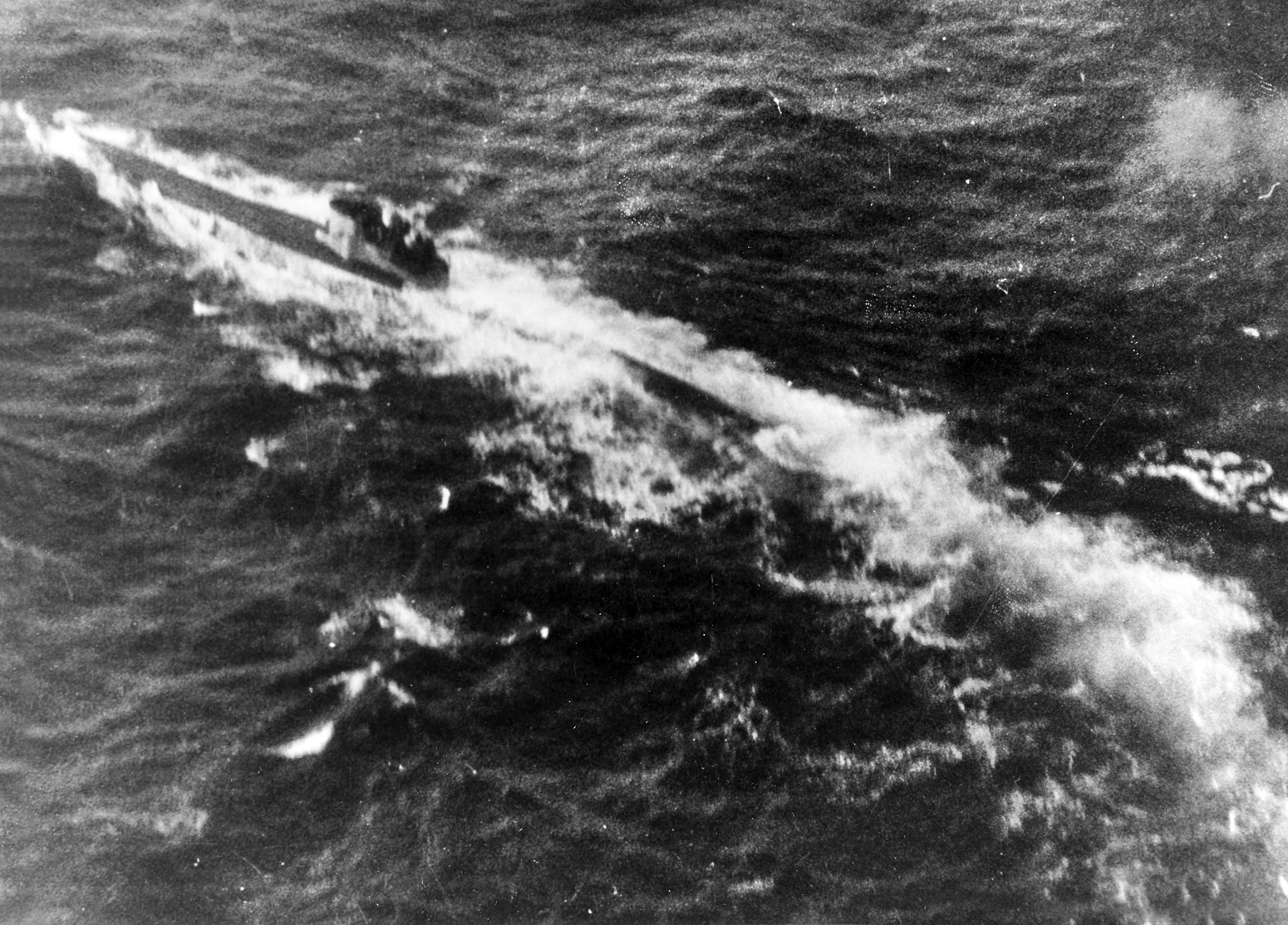 As World War II progressed, Allied anti-submarine defenses improved steadily, inflicting heavy losses on German U-boats in the Atlantic. In this photo, a submarine believed to be U-402 is shown under intense air attack in October 1943. 