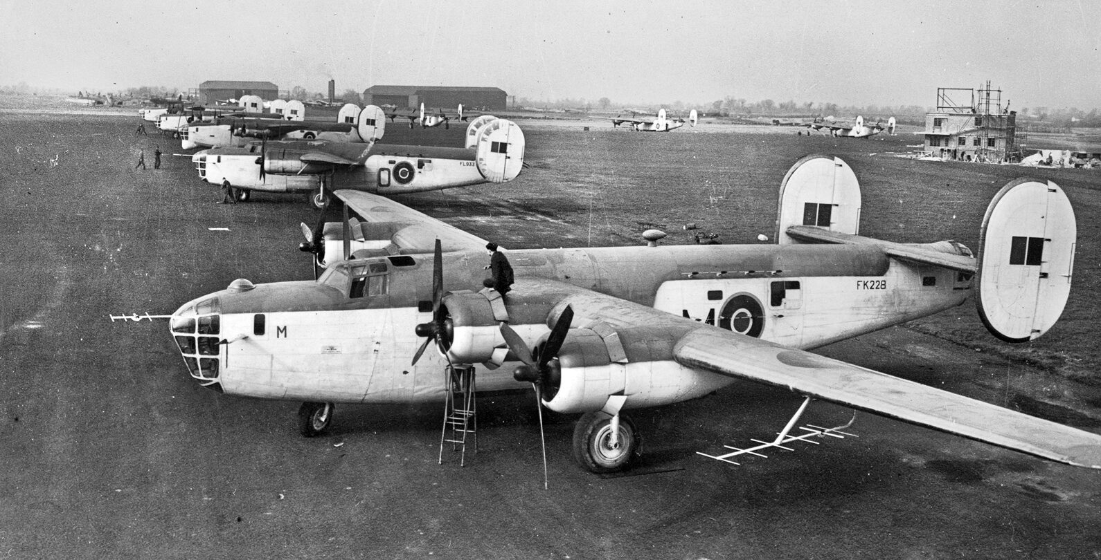 Consolidated B-24 Liberator bombers, modified to hunt Nazi U-boats and in service with Royal Air Force Coastal Command, sit ready to take off for anti-submarine patrols. 