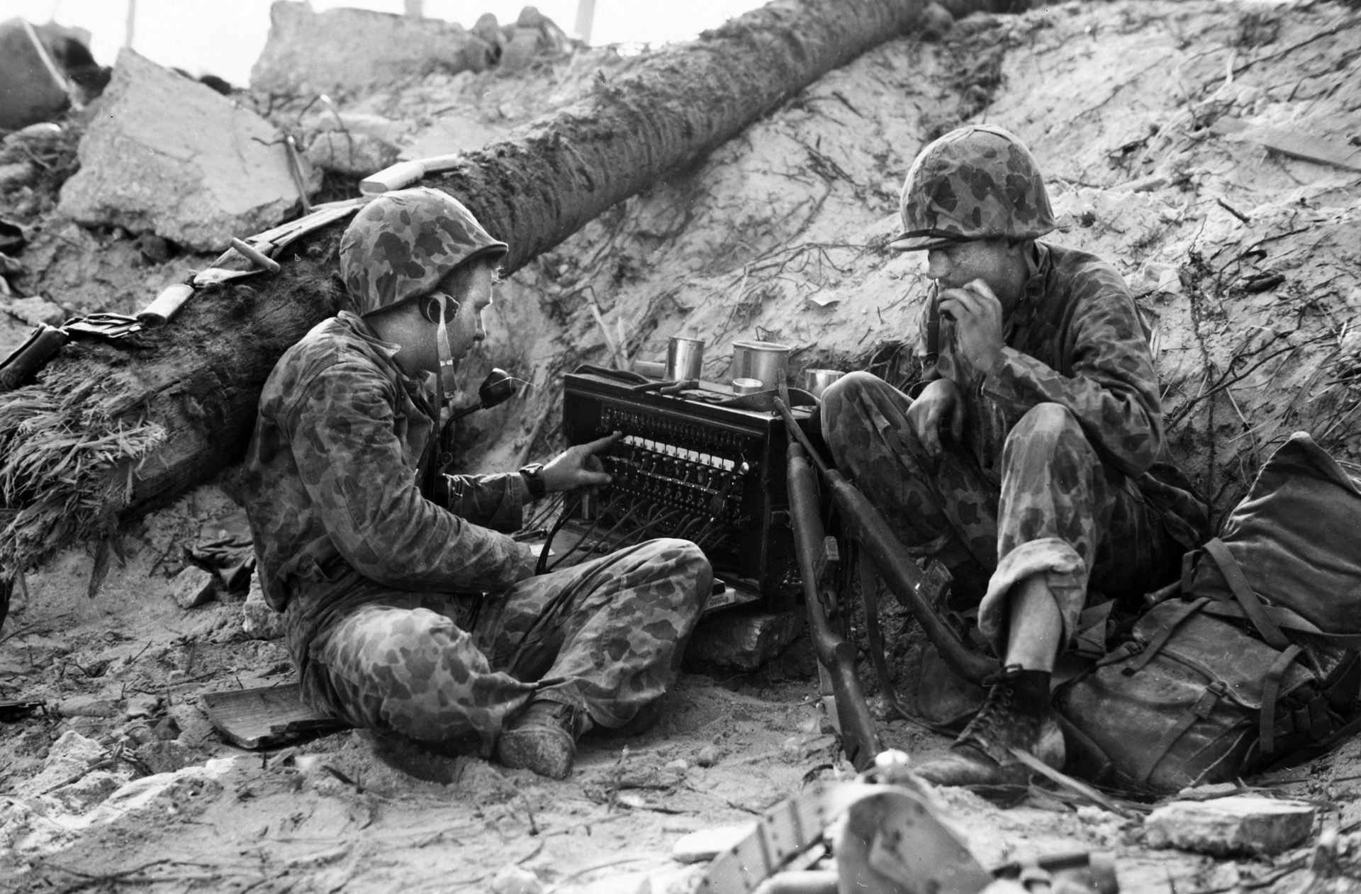 Two Marines of the 2nd Division operate a radio on the embattled islet of Betio during the assault on Tarawa Atoll in November 1942.