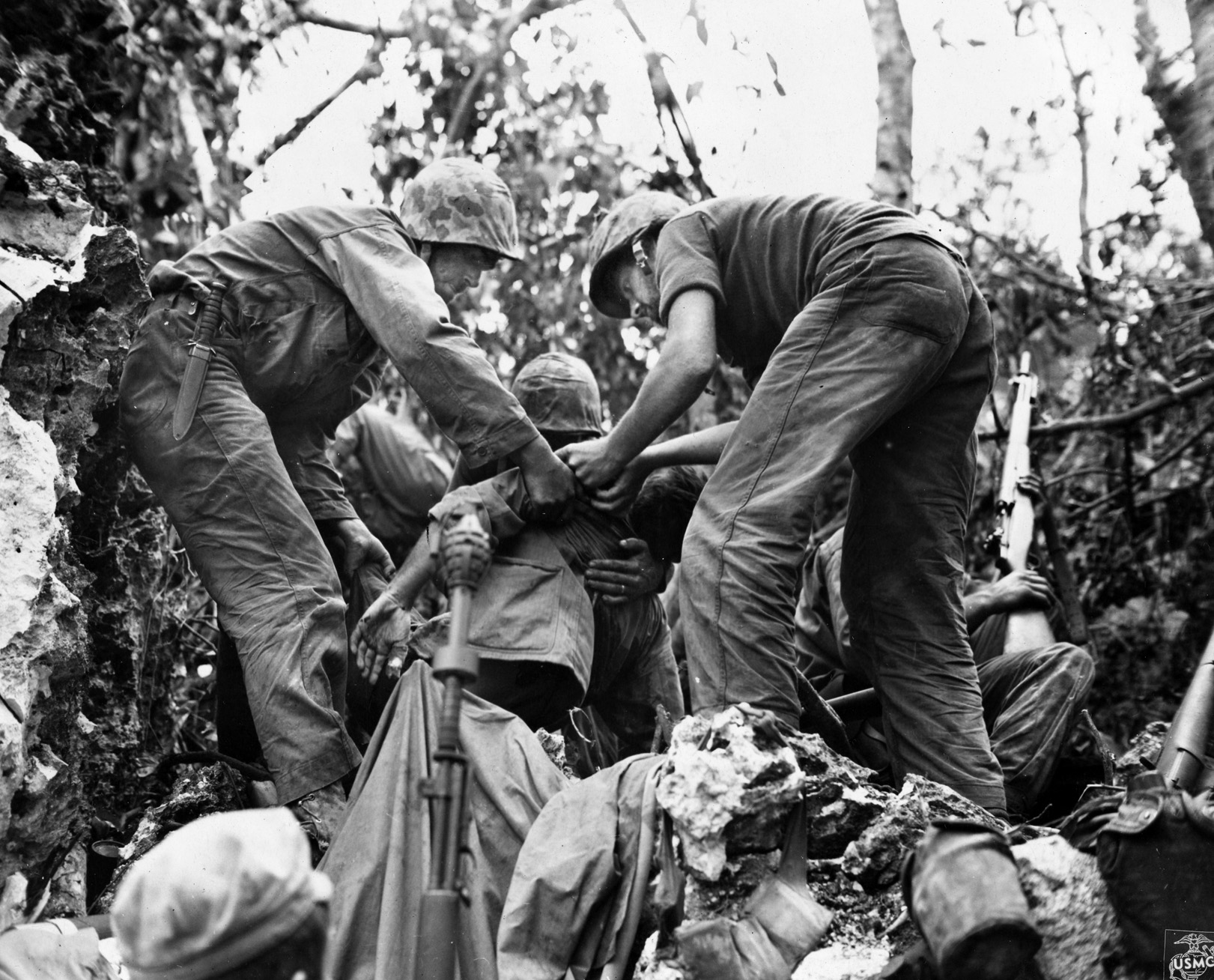 Marines catch the lifeless body of a comrade who has just been shot by a Japanese sniper on Peleliu during the fight for high ground that came to be known as ‘Suicide Ridge.’ 
