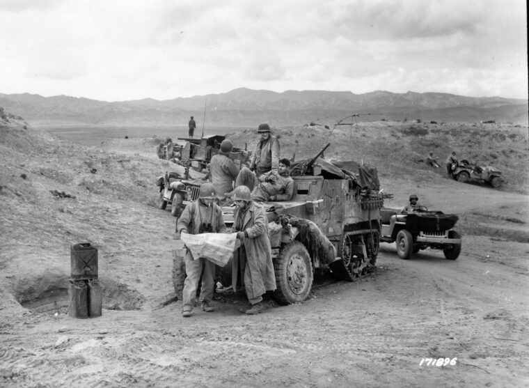 Officers and men of the 601st Tank Destroyer Battalion deployed near El Guettar in 1943. An M3 Tank Destroyer is visible in the background.