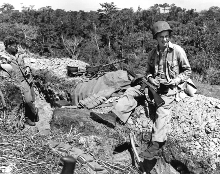A Marine on Guadalcanal waits for “chow call” while manning a trench near the front lines.