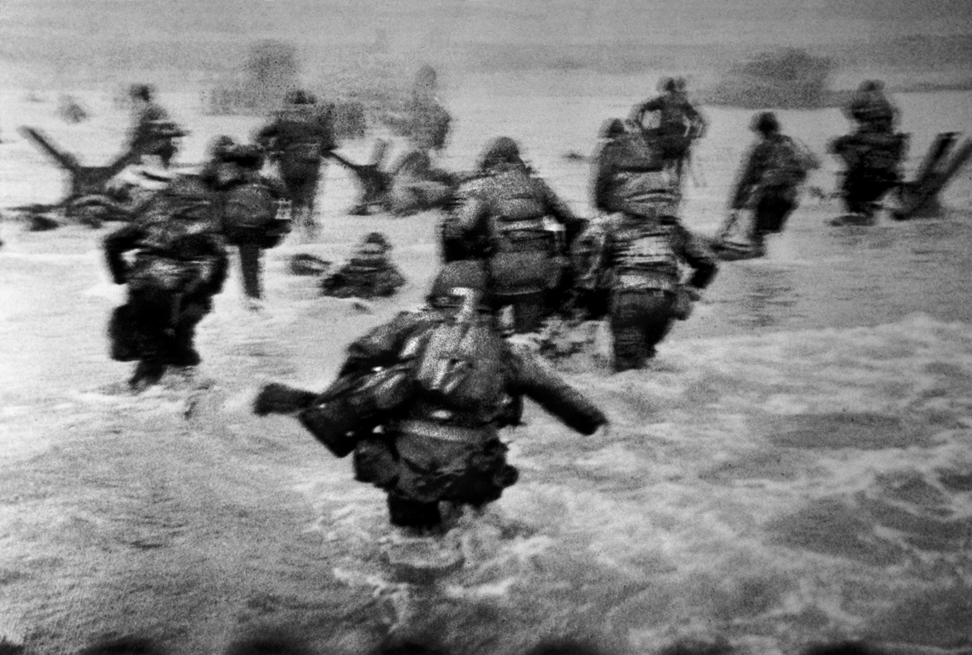 Robert Capa’s famous blurry image of the 1st Infantry Division’s amphibious landings at the Easy Red/Fox Green sectors of Omaha Beach indelibly captures the fear and chaos of the D-Day invasion. Four rolls of Capa’s film were rushed back to LIFE magazine’s London office, where a darkroom mistake ruined all but 11 images.