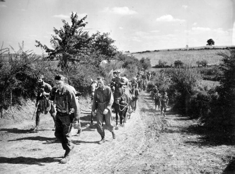 American OSS officers accompanied by Chetnik guerrillas on the move from the original evacuation airstrip in Pranjani, Serbia in anticipation of Soviet Red Army advances, September 10, 1944. The OSS officers were part of OSS operations Halyard and Ranger.