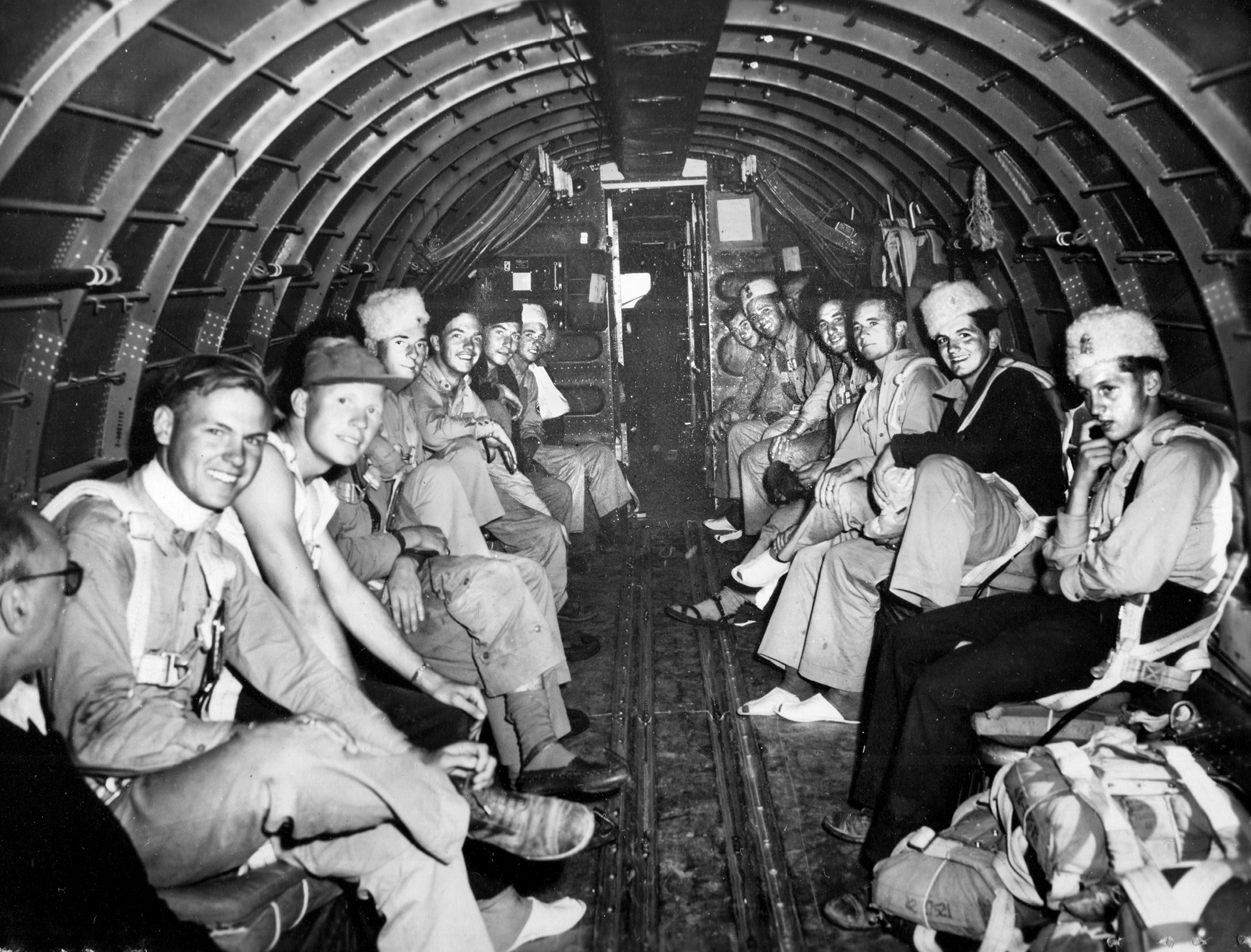 Smiling in anticipation of their return to Allied territory, a group of downed airmen sit aboard a C-47 transport plane. This photo was taken during a flight from an airstrip at Koceljeva on September 17, 1944.