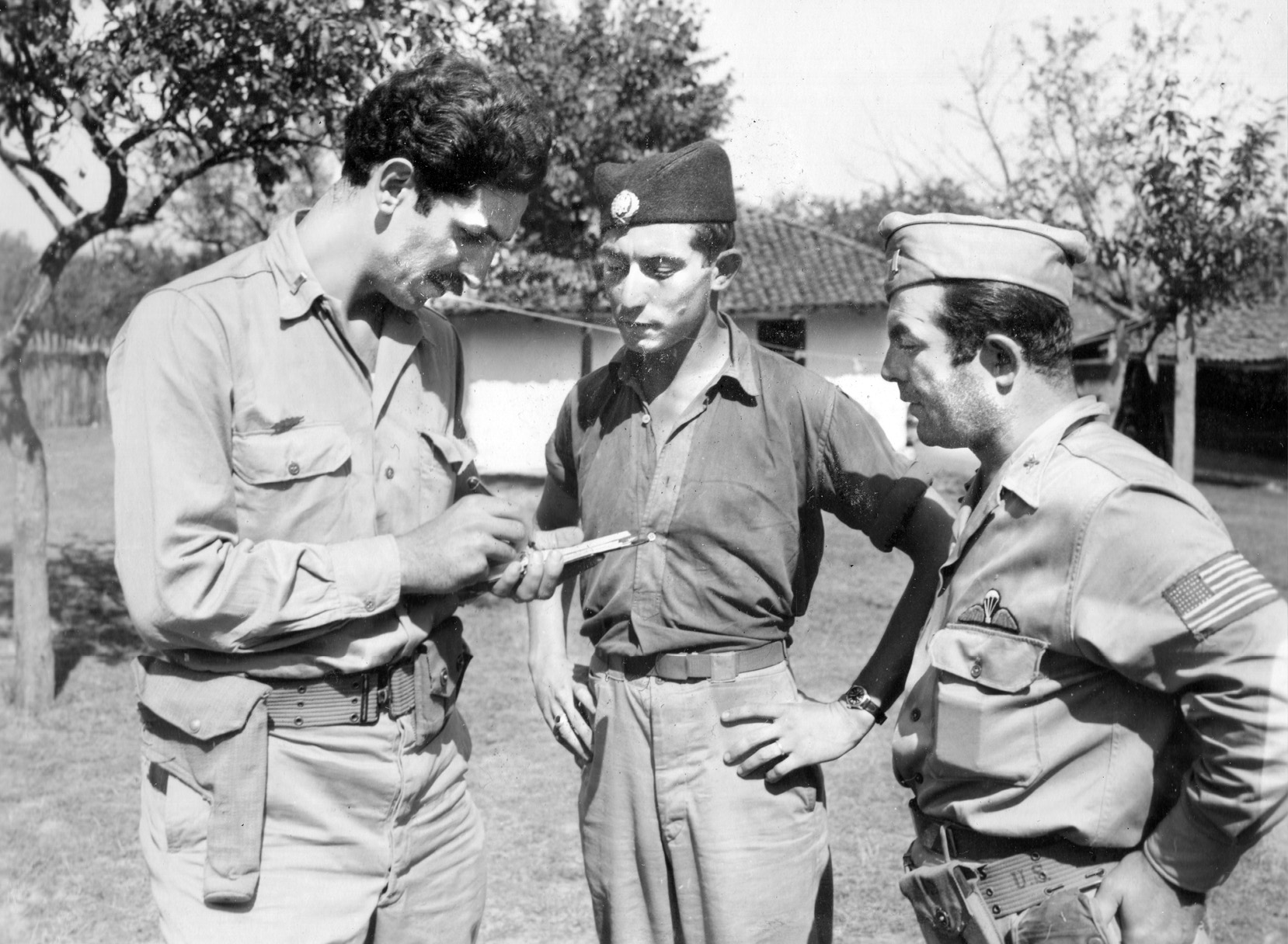 Lieutenant Lloyd G. Hargrave (center), a P-51 Mustang fighter pilot who was shot down 10 miles south of the Yugoslav capital of Belgrade, is questioned by OSS Captain Nick Lalich (left) and OSS Lieutenant Mike Rajacich (right).