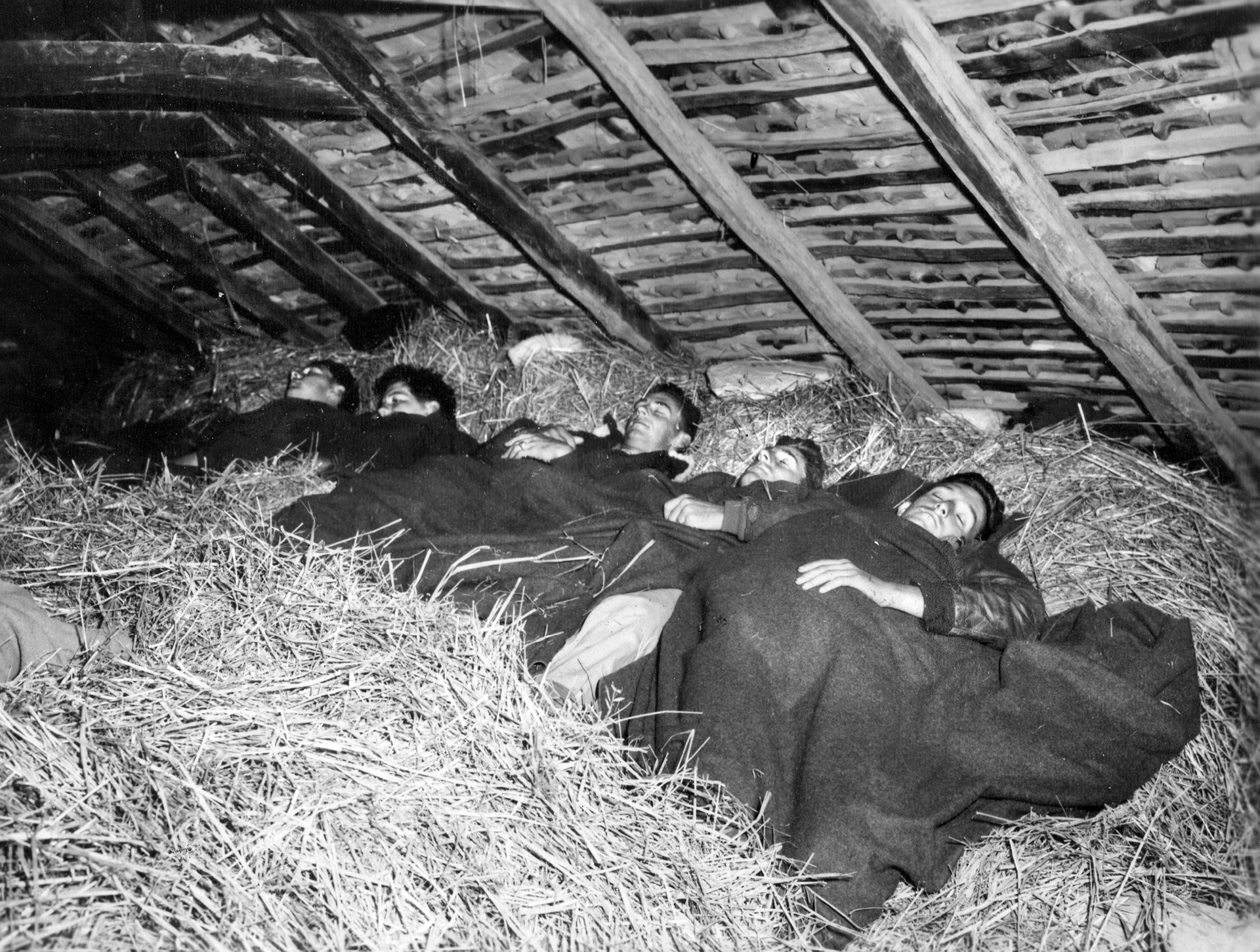 As they await air rescue via Operation Halyard, a group of American airmen get some sleep in a hayloft somewhere in Yugoslavia. A cooperative effort to get downed airmen out of Nazi-occupied territory, Operation Halyard was a remarkable success.