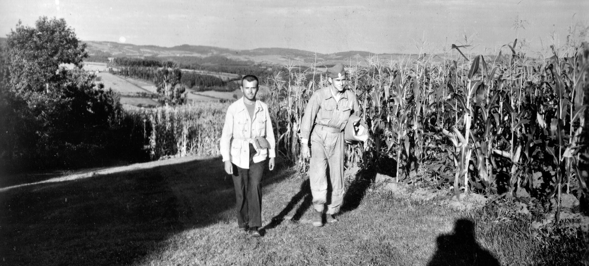 Chetnik fighter Radmilo Widojewic leads Lieutenant James D. Beckham, a P-51 fighter pilot shot down during a mission over Yugoslavia in September 1944, to a collection center.