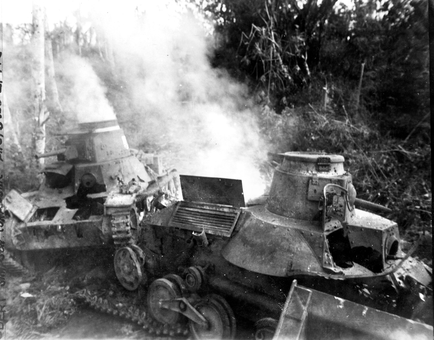 Smoldering hulks of two Japanese Type 95 ‘Ha-Go’ tanks lie abandoned after the fight. The Japanese used their light tanks successfully against the Americans. 