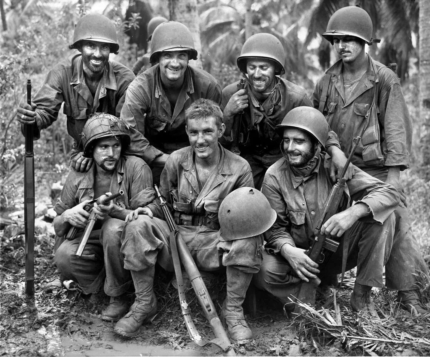 Private William N. Wade, a soldier of the 77th Division, poses at center with comrades after the battle for Barrigada. Wade was lucky to survive when his helmet was penetrated by a Japanese sniper’s bullet. 