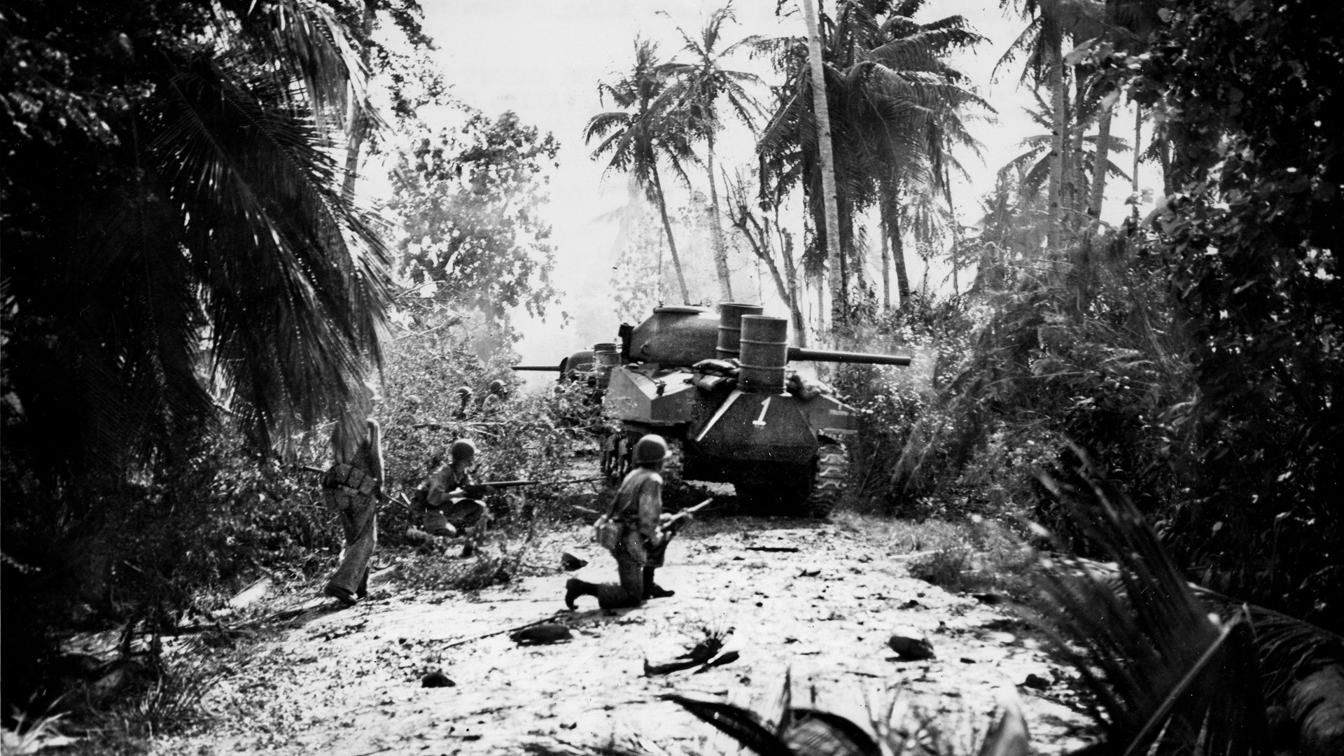 A pair of M4 Sherman medium tanks from the 706th Tank Battalion leads the way for U.S. Marines advancing through the jungle on the island of Guam in the summer of 1944. The Sherman’s 75mm cannon outgunned Japanese tanks and suppressed Japanese sniper fire.