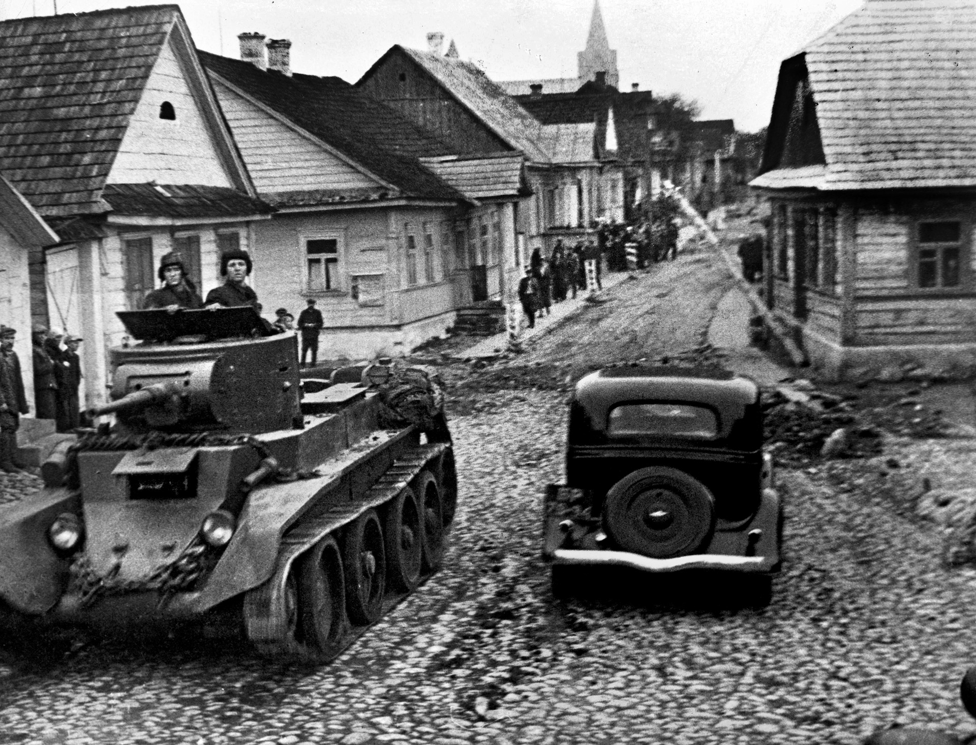A Red Army tank rolls along a dirt road in the Polish town of Rakov.