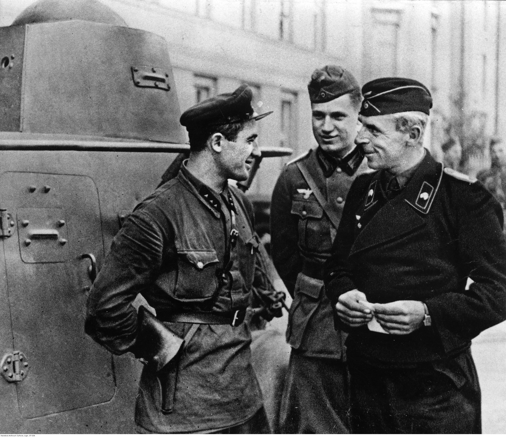 After their marauding columns have achieved their objectives and halted, German soldiers engage a Red Army soldier in conversation in the city of Brest-Litovsk. The city held historical significance for both Germany and the Soviet Union, as it was the site of the peace-treaty signing with the Germans that extricated Bolshevik Russia from World War I. 