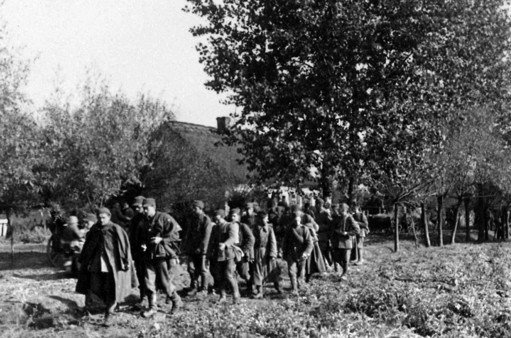 A dazed group of Polish troops, captured by the invading Germans after being cut off and forced to surrender, makes its way toward a rear area. 