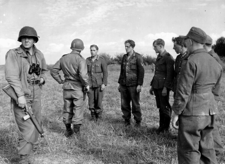 An American officer interrogates two recently captured German soldiers somewhere in France.