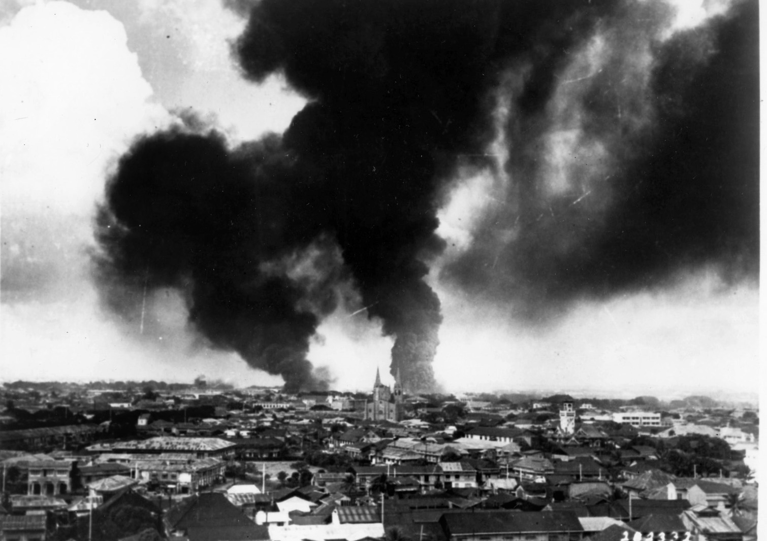 Smoke rises from demolished buildings in the Philippine capital of Manila following a December 1941 Japanese air raid. Manila was later declared an open city to avoid further damage.