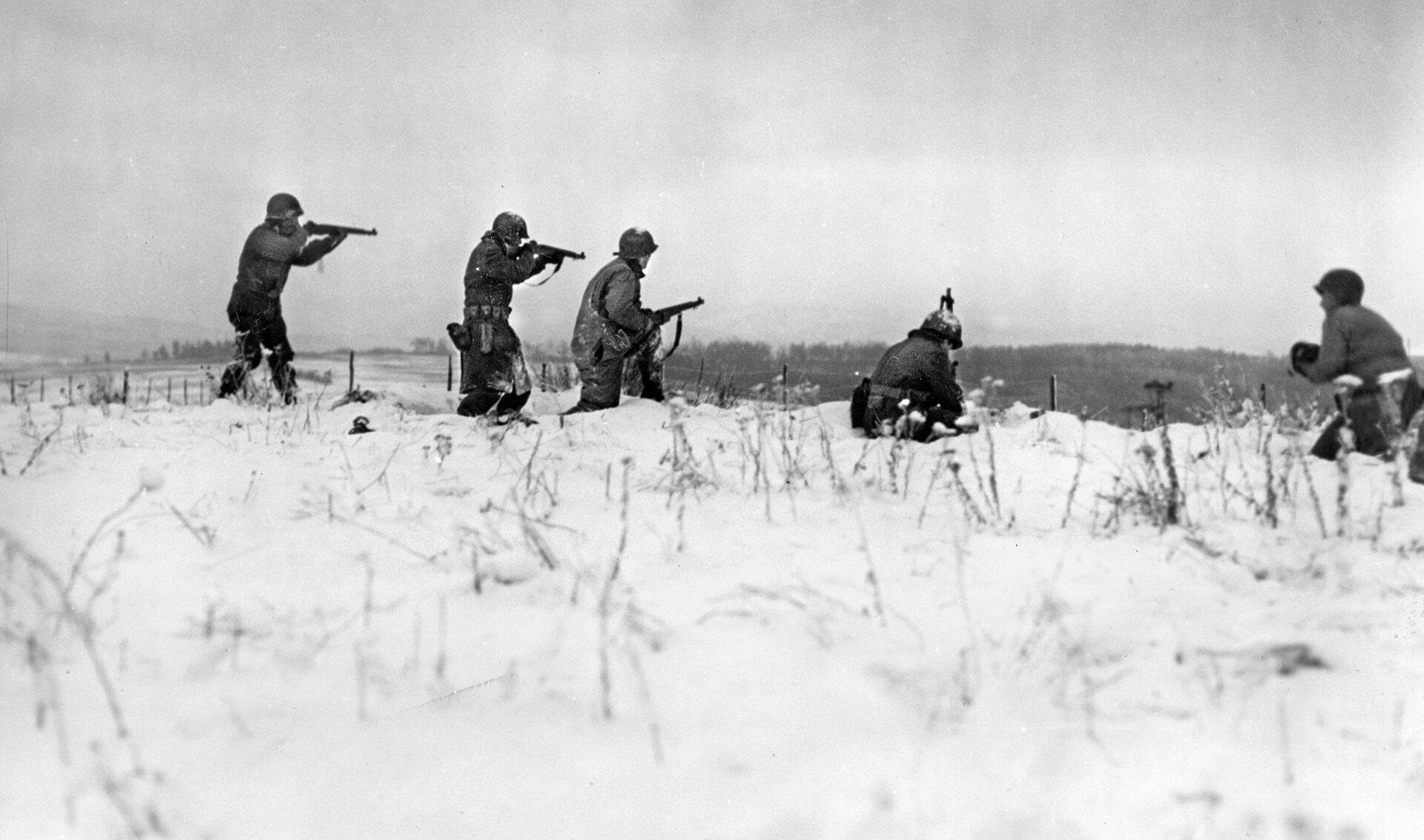 Soldiers with the 290th Infantry, 75th ID, fire on German snipers in Beffe Belgium on January 7, 1945. Bush fought in the snow and ice in Bastogne, and again near Beffe.