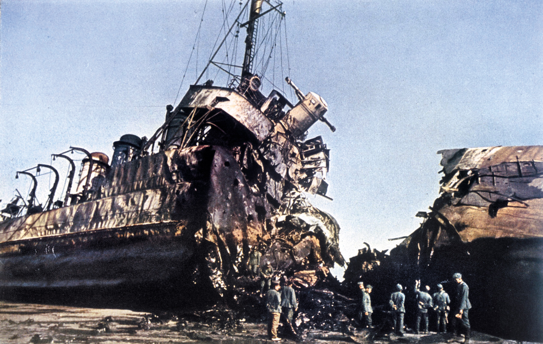 After the British have evacuated, German soldiers inspect the hulk of a ship beached at Dunkirk. The vessel was wrecked by a single Luftwaffe bomb that detonated, cutting the ship in half.