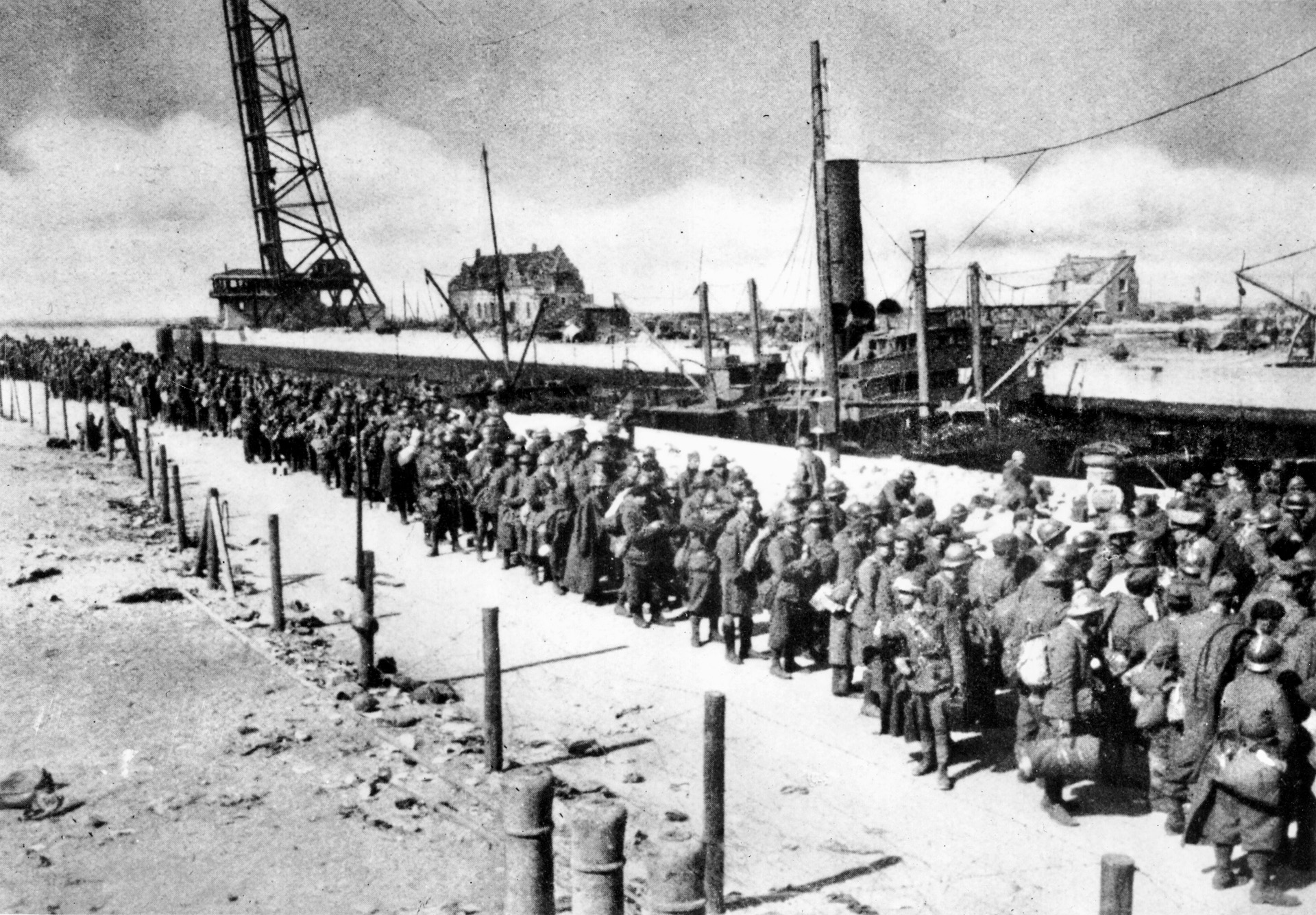 British and French soldiers await instructions from their captors on the now-calm beachfront. Many who fought the rearguard action at Dunkirk and were unable to escape the Germans became prisoners.