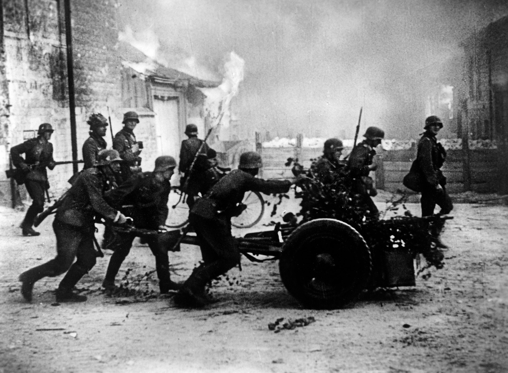 Pressing the perimeter of the Dunkirk defenses, German soldiers manhandle a 37mm PAK 36 gun into firing position. Adolf Hitler halted the ground campaign to allow the Luftwaffe to deliver the final blow at Dunkirk.