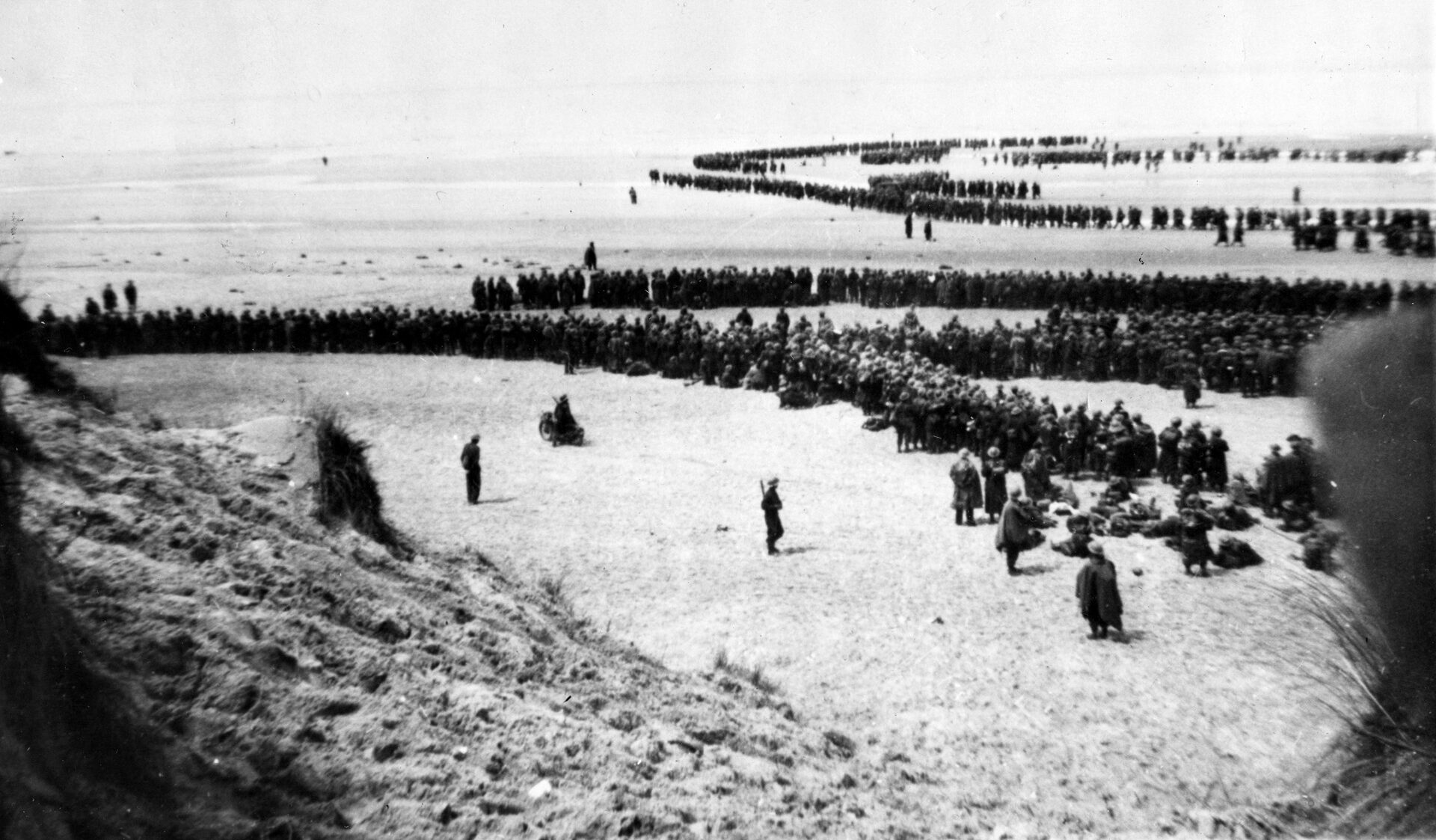 This iconic photo of British troops massed along the beach at Dunkirk provides a glimpse into the magnitude of Operation Dynamo. The sealift involved both military and civilian watercraft crossing the English Channel.