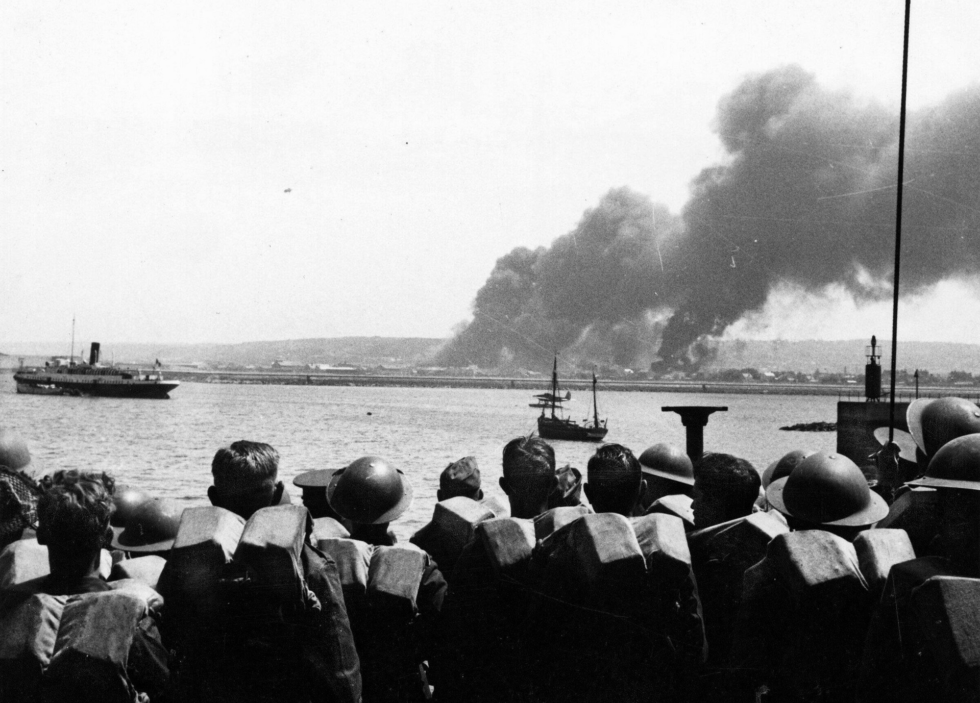 Evacuated British soldiers aboard the ship SS Nomadic watch warehouses burn in the French port city of Cherbourg in this photo taken in June 1940 at the height of Operation Dynamo.