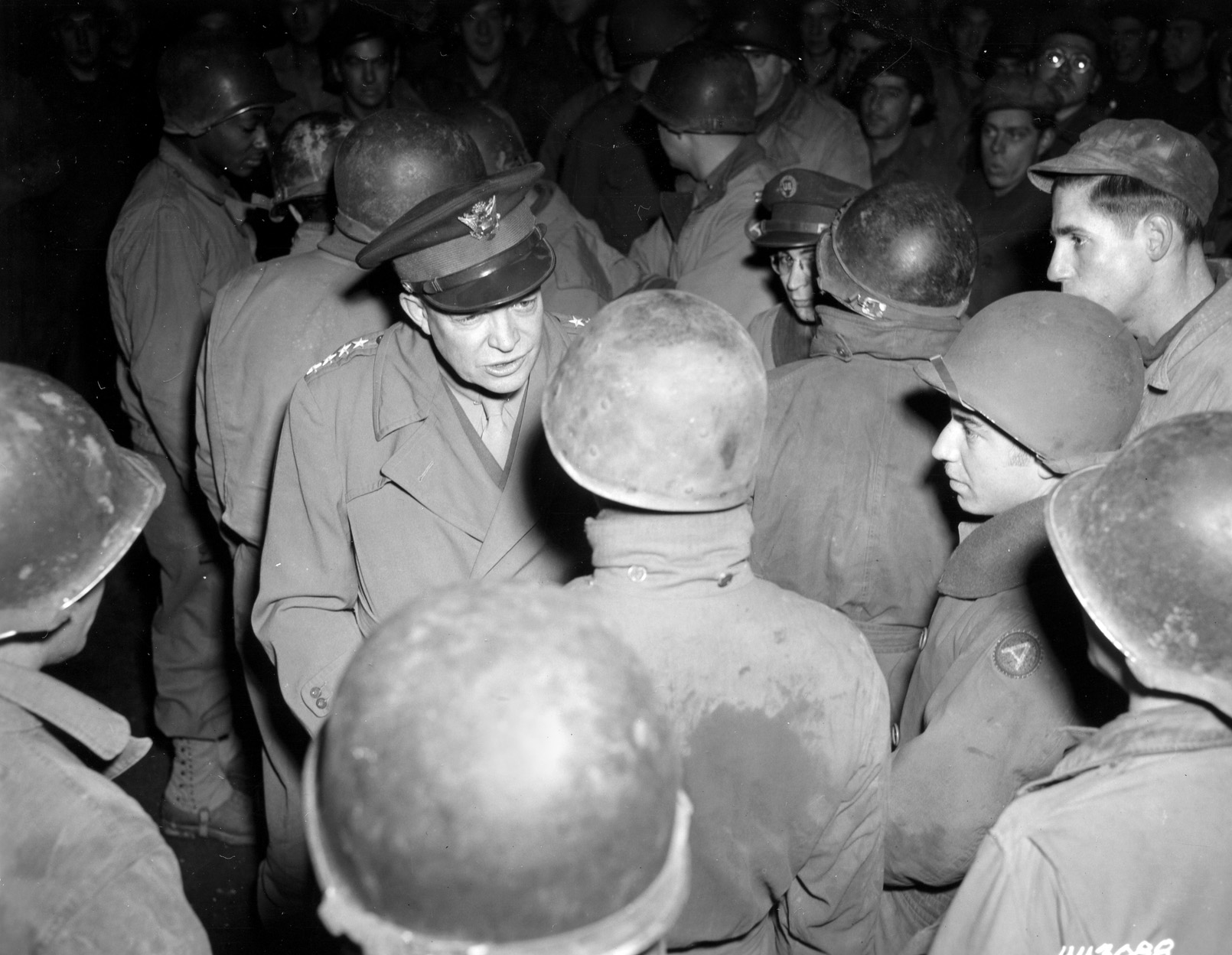 Eisenhower chats with ordnance troops on the front line during his tour of Patton’s sector in Nancy, France.
