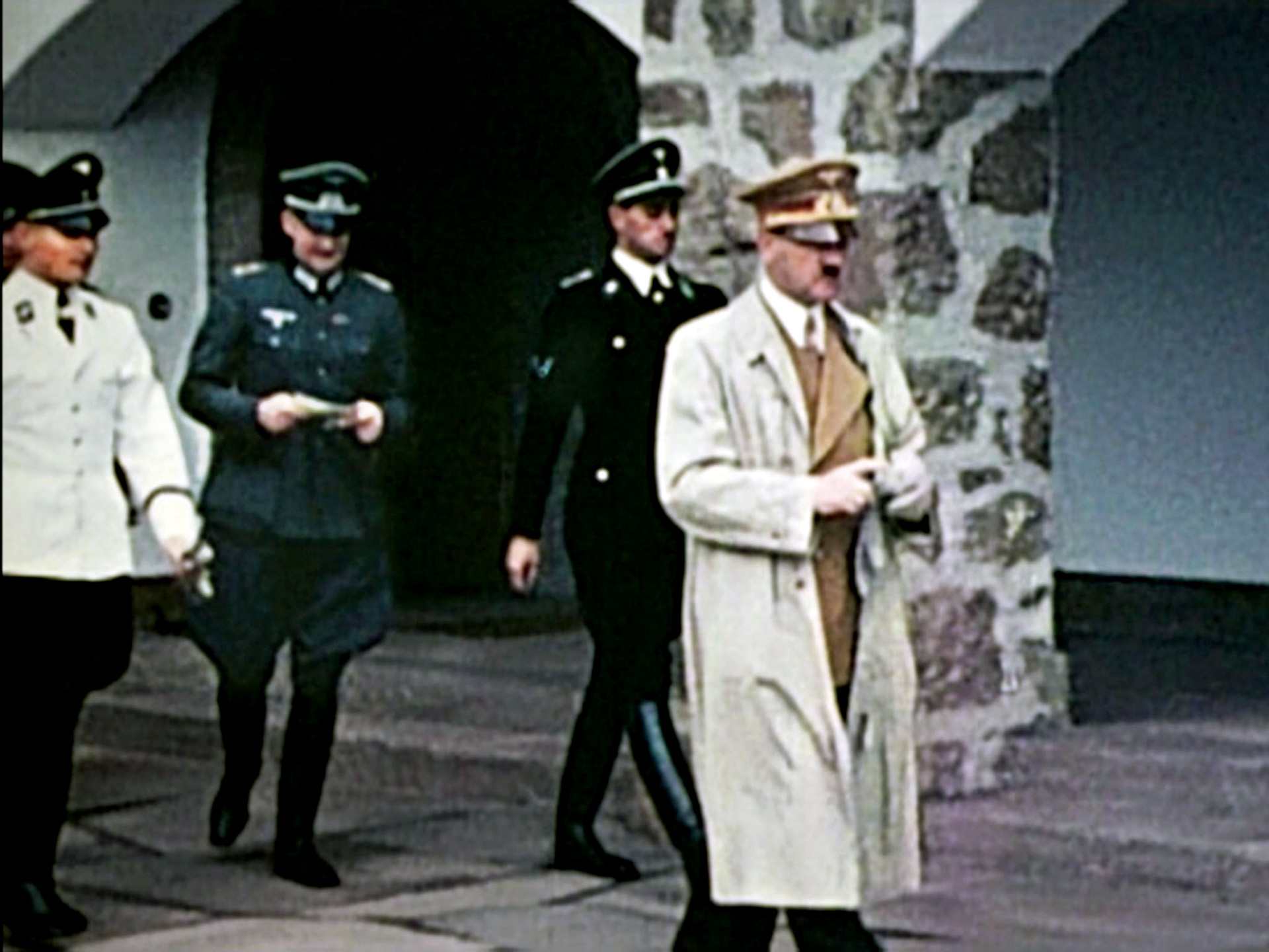 Hitler departs Berchtesgaden with an entourage of Nazi officers trailing behind. He purchased the original house in 1933 with royalties from his book Mein Kampf, and in the years that followed, Berchtesgaden became an alpine showplace. 