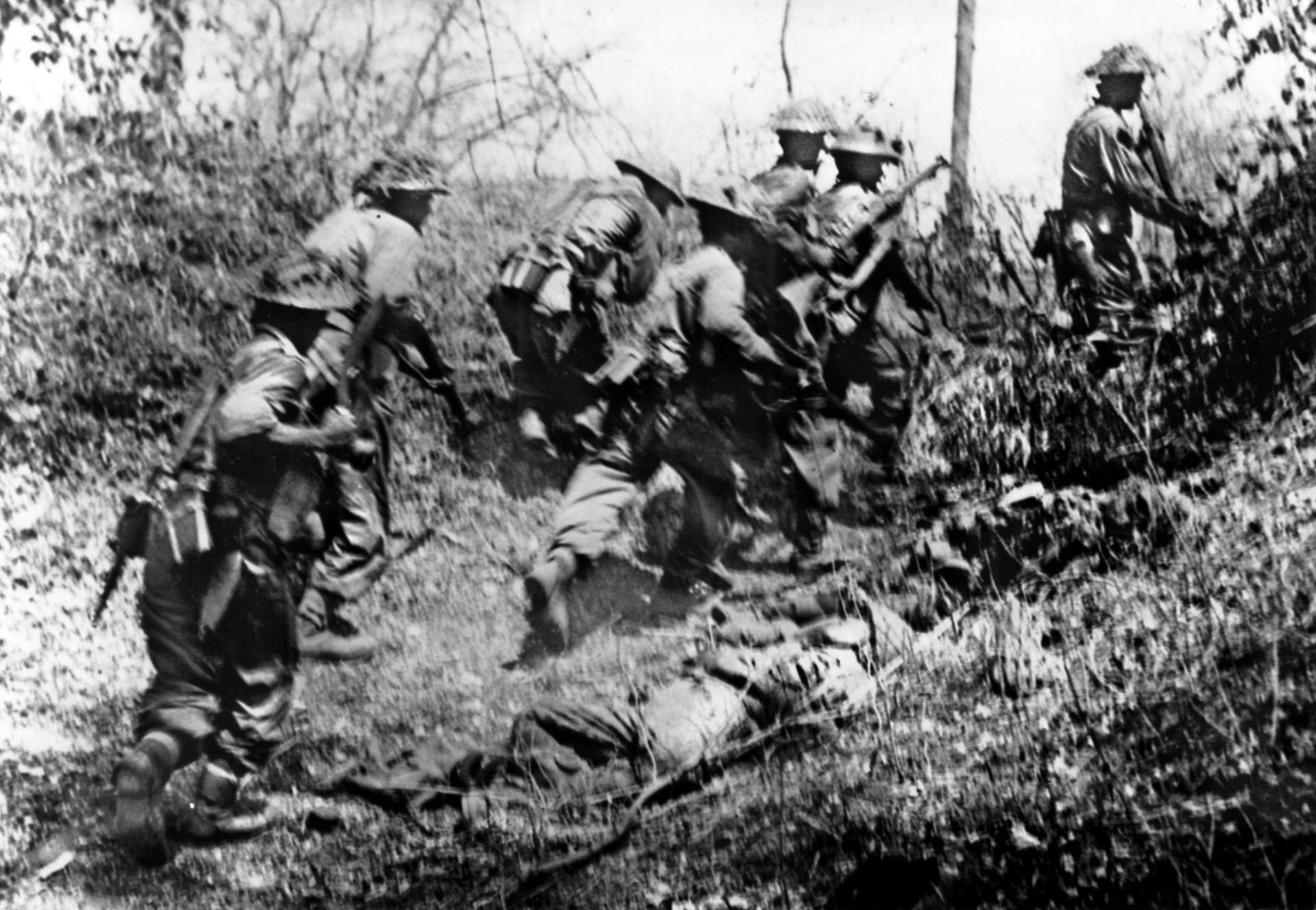 Swiftly pressing their advantage, British soldiers rush past the body of a dead Japanese soldier during the advance on Meiktila in the spring of 1945. The capture of Meiktila, a vital communications center, severed links between Japanese troops and Rangoon.