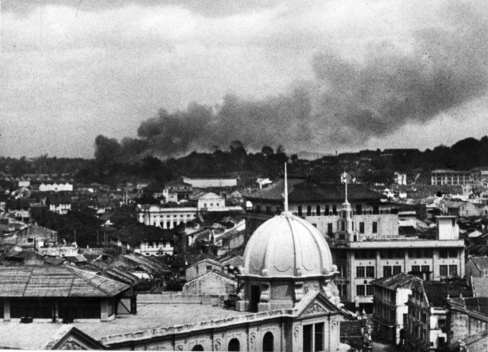 Smoke billows from an area of Singapore following a Japanese air raid in early 1942. The advancing Japanese moved swiftly down the Malay Peninsula and captured Singapore in an impressive feat of arms.