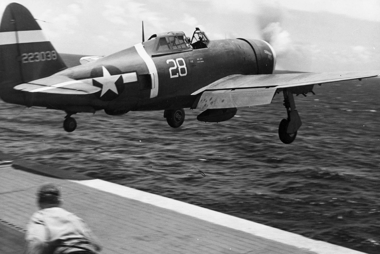 This P-47D flies off the deck of the escort carrier USS Manila Bay to attack an approaching formation of Japanese Aichi Val dive bombers east of the island of Saipan in the Marianas.