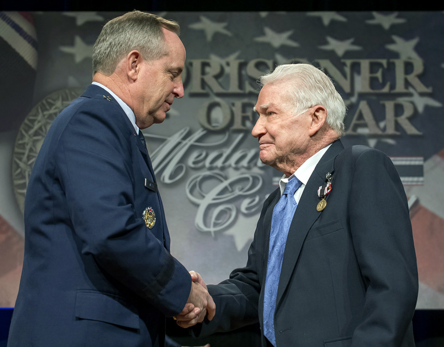 Staff Sergeant John Fox (right), held prisoner  at the Wauwilermoos camp in Switzerland,  receives the Prisoner of War Medal in 2014 from Air Force General Mark Welsh III.