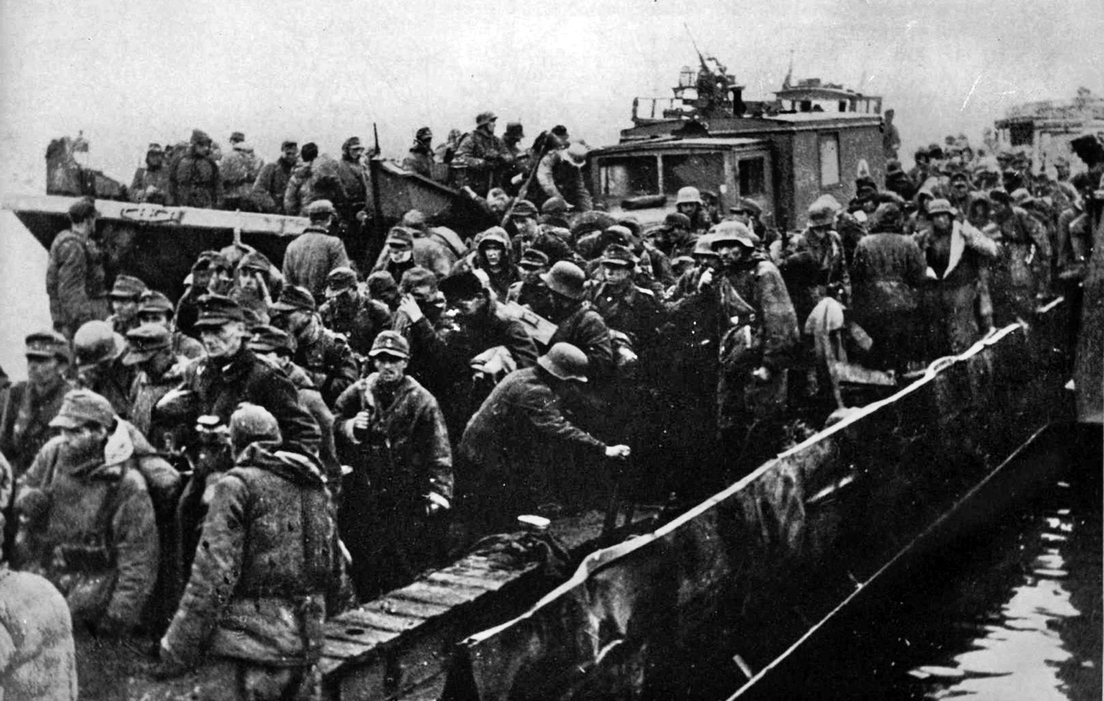 Grand Admiral Dönitz defied Hitler’s “no retreat, no surrender” orders and pulled German ground units (shown here piling into small boats) out of the Courland Pocket to be repositioned further west in accordance with Operation Hannibal. 