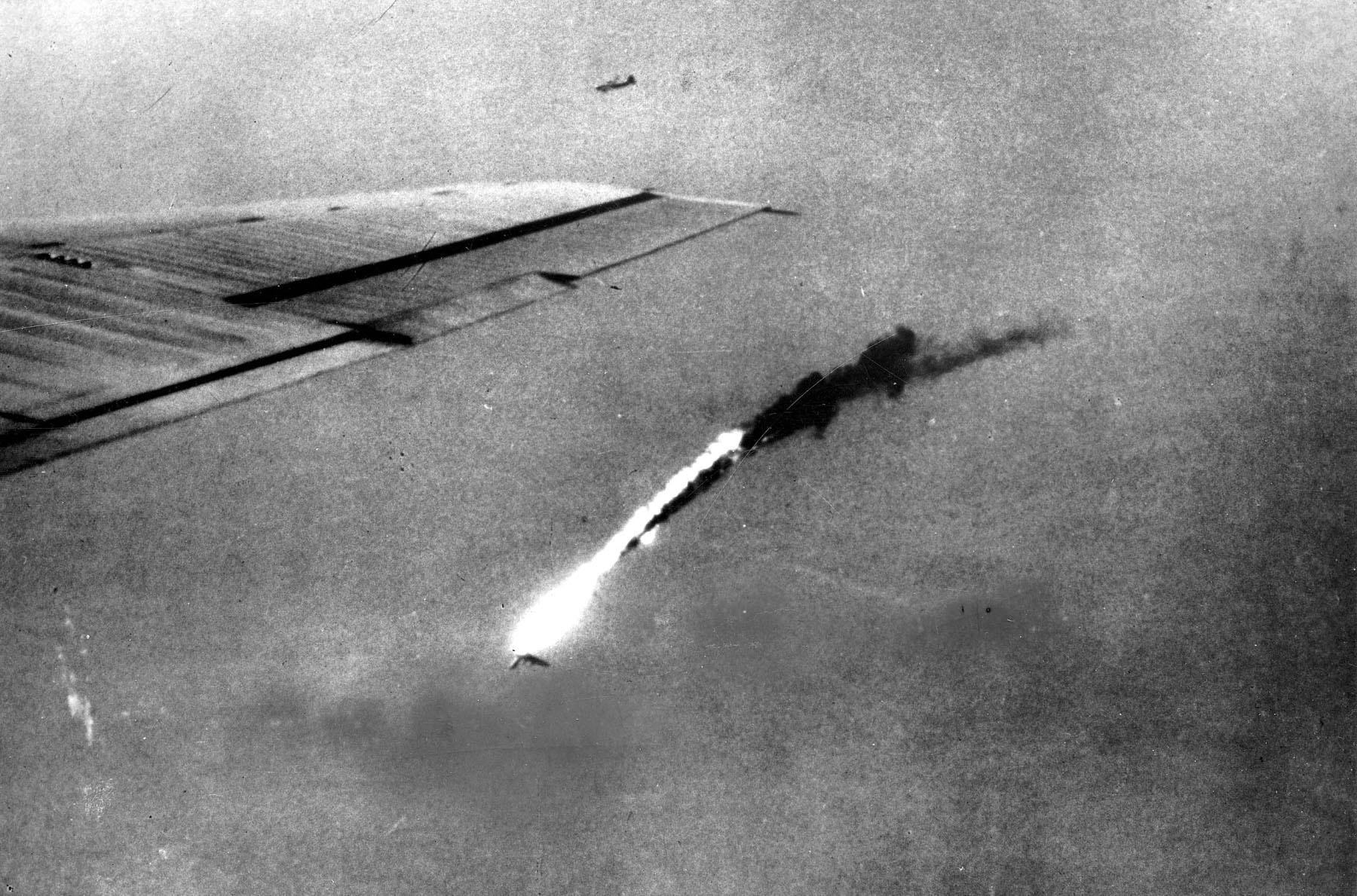 Despite beliefs to the contrary, B-29s, like this one with its wing shot away, were not immune from ground fire. 