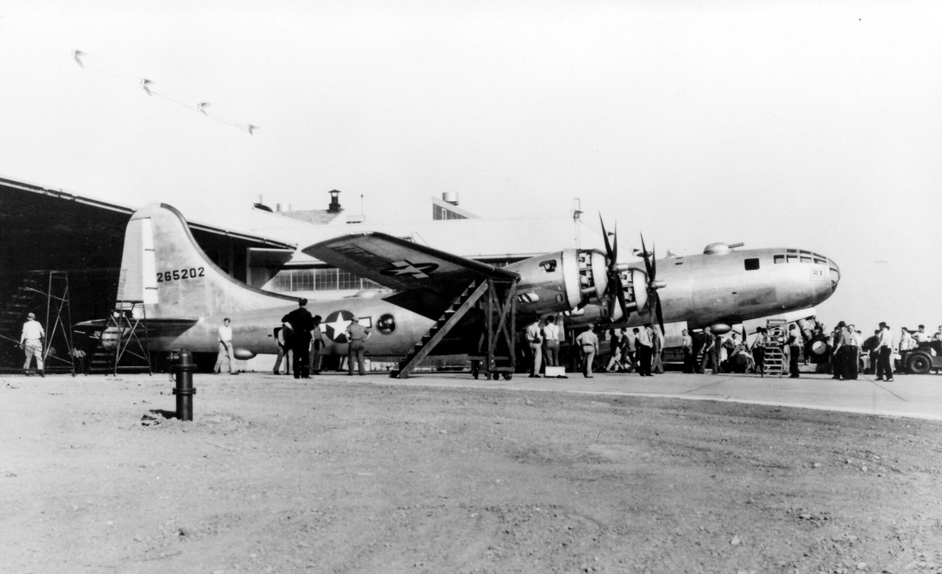 The first B-29 is rolled out of the Glen L. Martin-Nebraska Bomber Plant on May 24, 1944. The nose of the plane was raised to lower the tail and allow it to pass under the canopy doors.