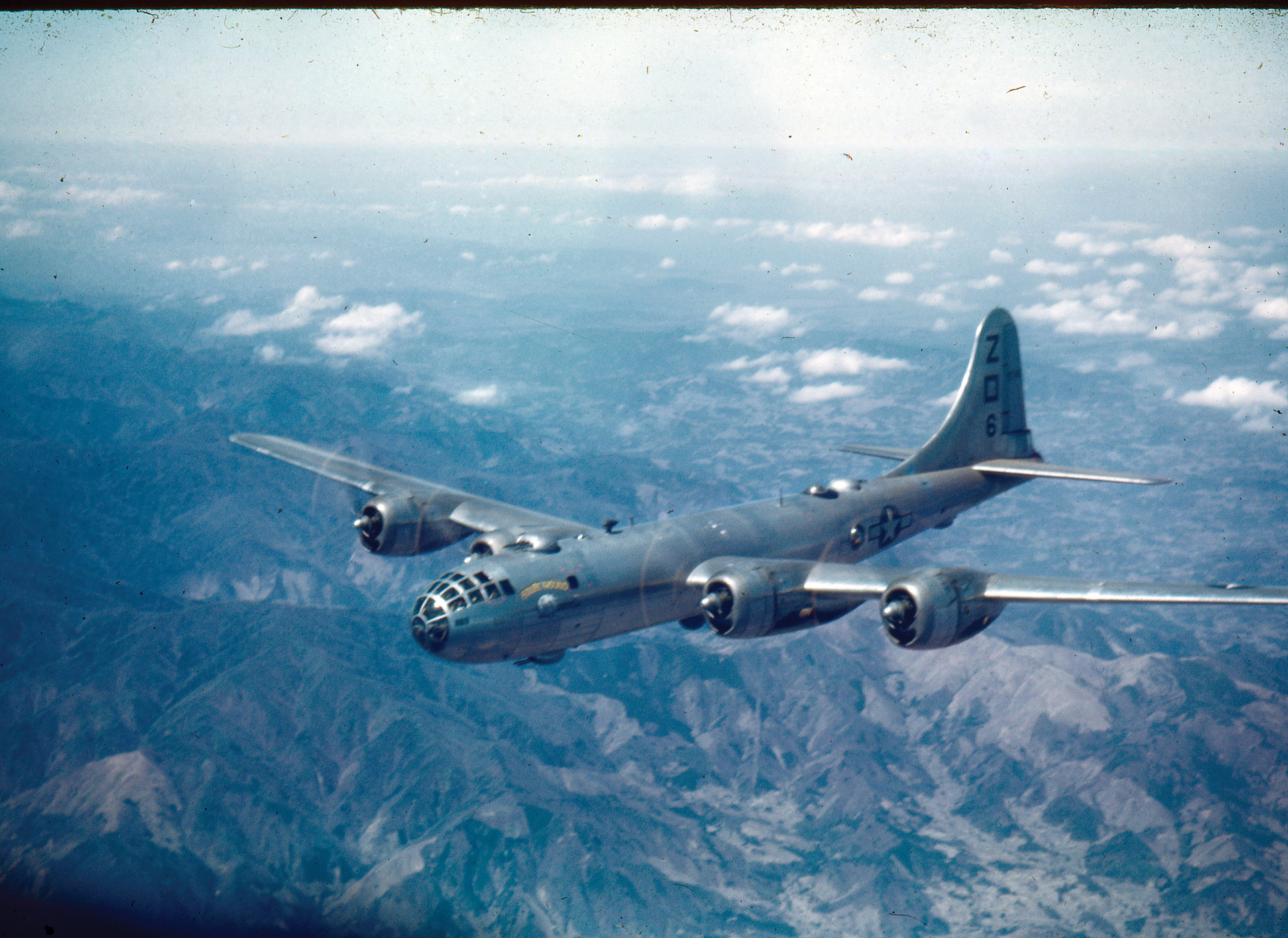 A B-29 named “Booze Hound,” 500th Bomb Group, 73rd Wing, flies over Saipan, 1945.