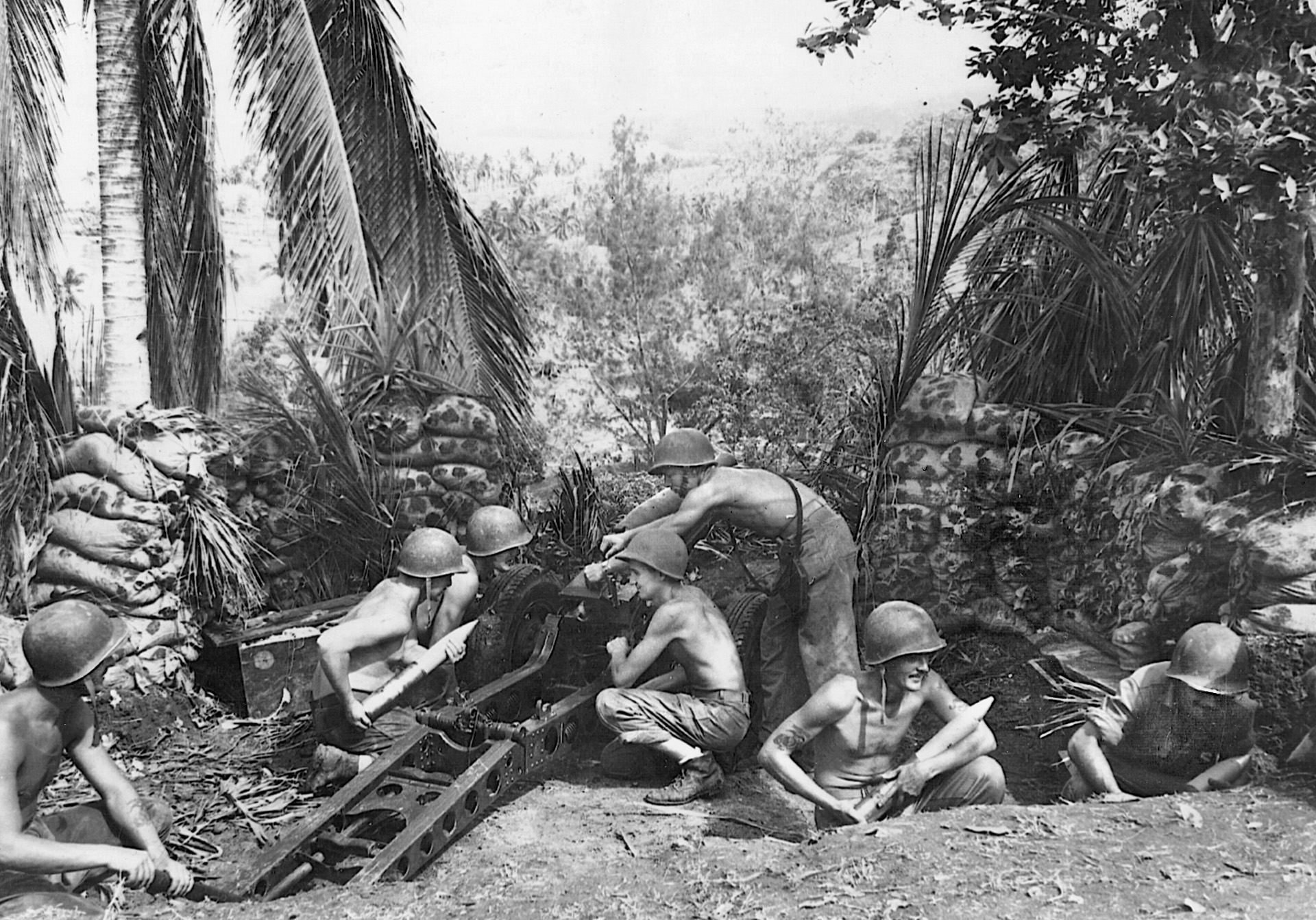 Occupying a former Japanese position, U.S. Marine artillerymen set up their field gun for action. Marine artillery fire was so effective on Guadalcanal that after one engagement a Japanese prisoner asked to see the “automatic” artillery that the Americans were using.