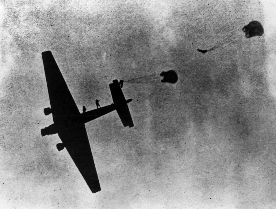 German paratroopers plummet from a Junkers Ju-52 transport plane. 
